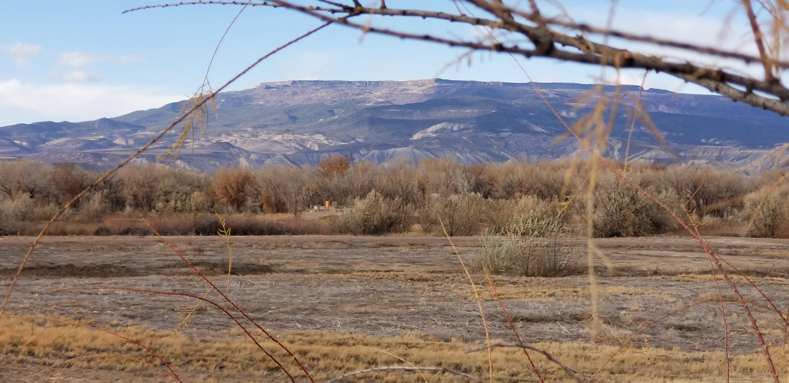 The confluence valley floor below the Grand Mesa